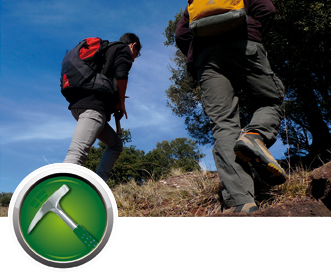 Two geologists with backpacks walking on the mountain